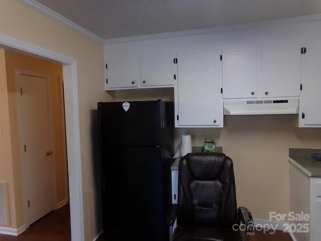 a kitchen with a refrigerator and cabinets