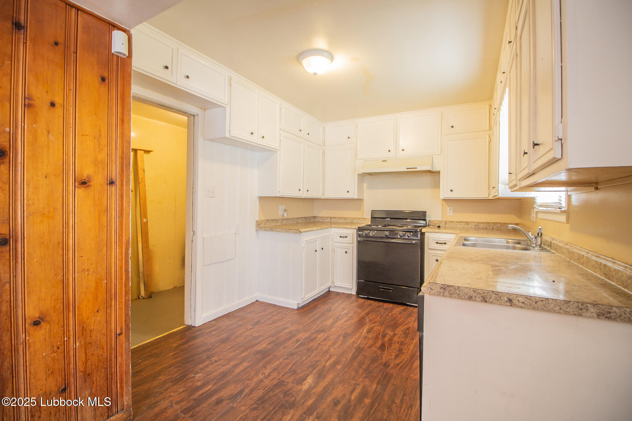 2414 38th Street Lubbock, TX 79412 - Photo 10 of 20 a kitchen with a refrigerator stove and a sink