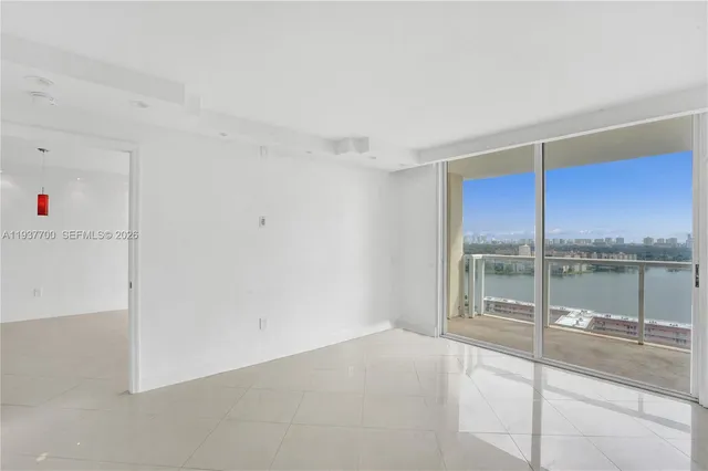 a view of a living room hardwood floor and a large window