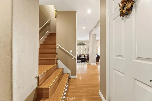 a view of entryway and hall with wooden floor