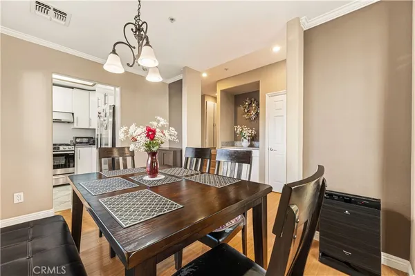 a view of a dining room with furniture and wooden floor