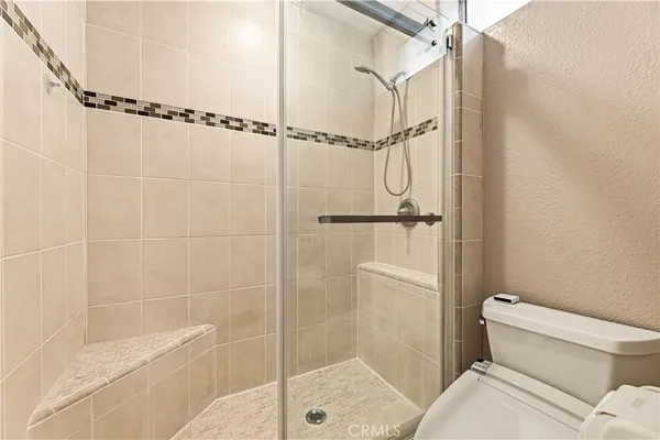 a bathroom with a shower and a toilet