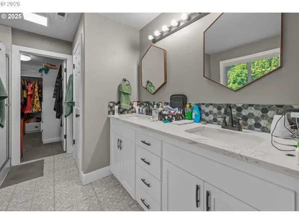 a spacious bathroom with a double vanity sink and a mirror