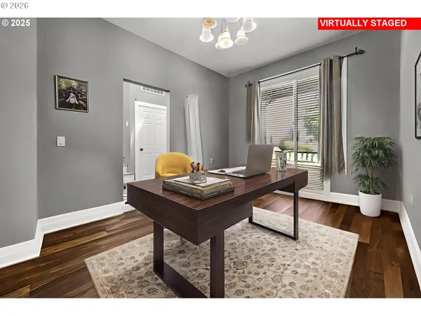 a living room with a table and a potted plant