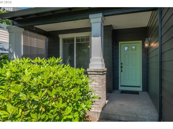 a view of a pathway of a house with potted plants