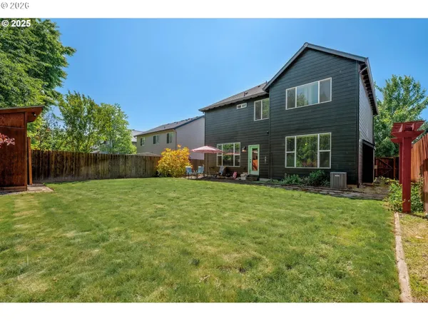 a front view of a house with a yard and trees