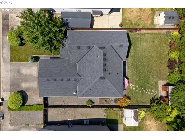 an aerial view of a house with a yard basket ball court and outdoor seating