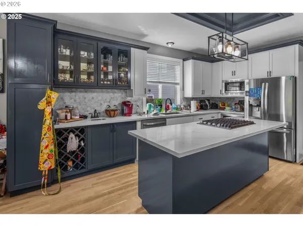 a kitchen with a sink appliances and cabinets