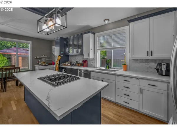 a kitchen with a stove a window and cabinets