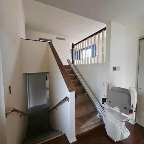 a view of an empty room with staircase