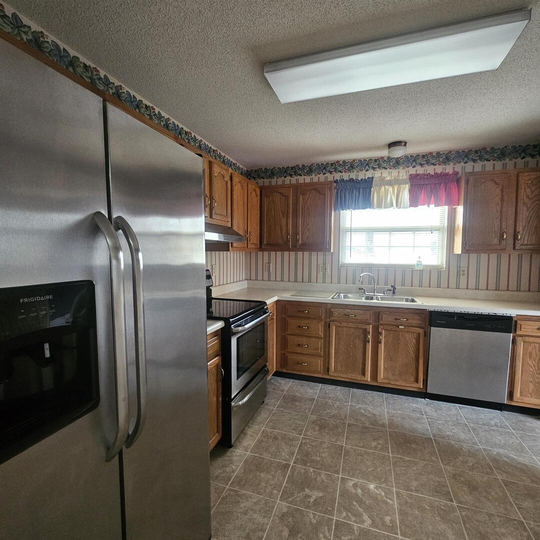 4412 Woodglen Lane Mount Vernon, IL 62864 - Photo 19 of 35 a kitchen with granite countertop a sink stainless steel appliances and cabinets