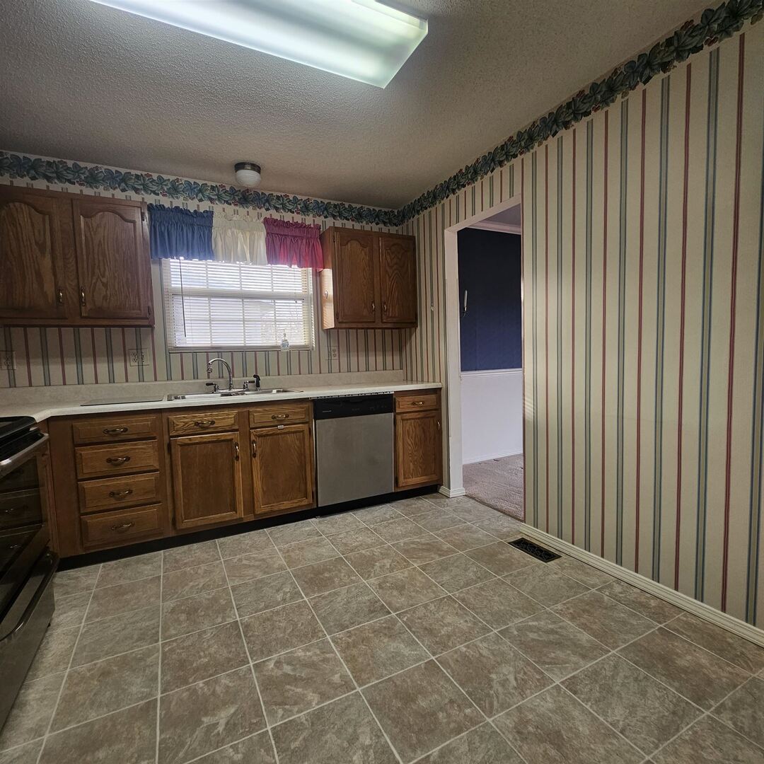 4412 Woodglen Lane Mount Vernon, IL 62864 - Photo 20 of 35 a kitchen with stainless steel appliances a sink stove and cabinets