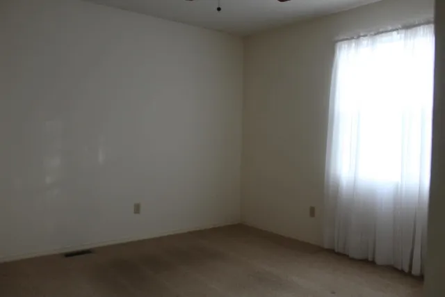 a view of empty room with a fireplace