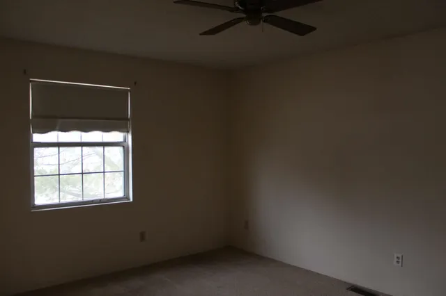 an empty room with a fireplace