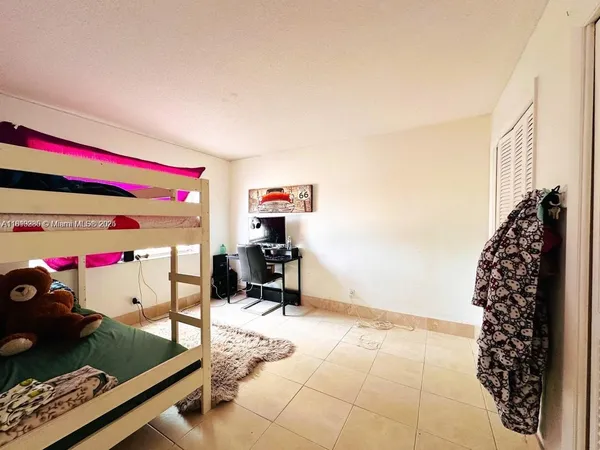 a bedroom with a bed and a tv
