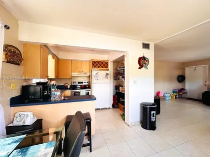 a kitchen with stainless steel appliances granite countertop a sink and cabinets