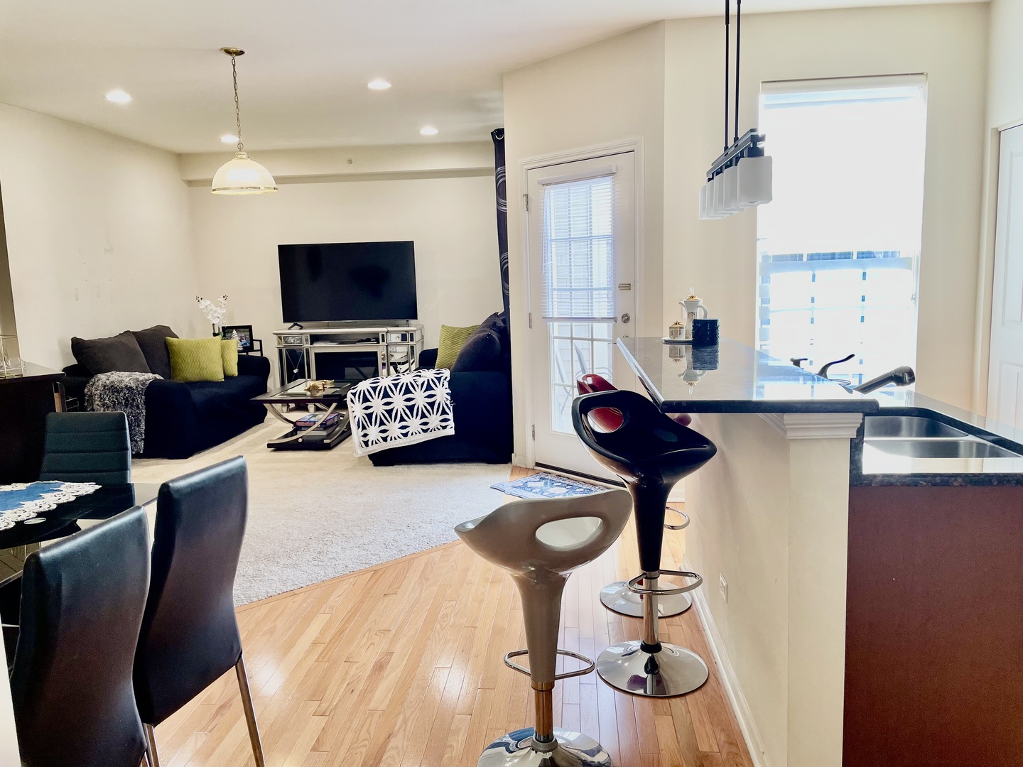 2018 Shermer Road, Unit 2018 Glenview, IL 60026 - Photo 11 of 39 a living room with furniture a flat screen tv and kitchen view