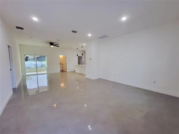 an empty room with fireplace and windows