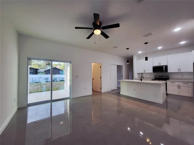 a view of kitchen with refrigerator and window