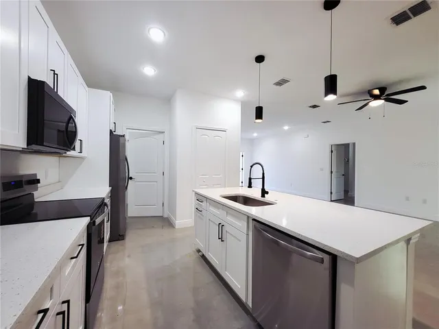 a kitchen with a sink stainless steel appliances and cabinets