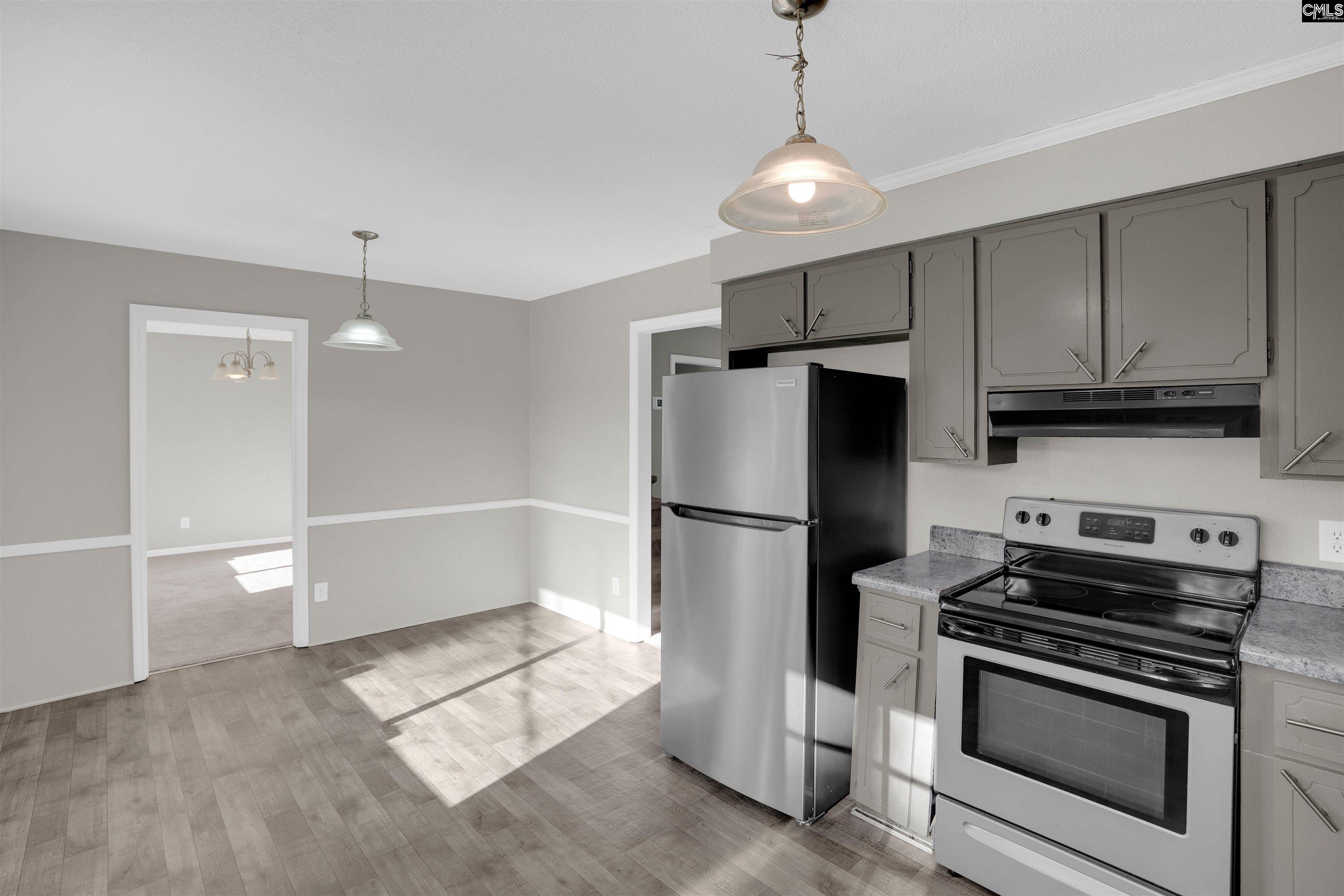 2620 Pleasant Ridge Drive Columbia, SC 29209 - Photo 11 of 37 a kitchen with stainless steel appliances a refrigerator a stove and white cabinets