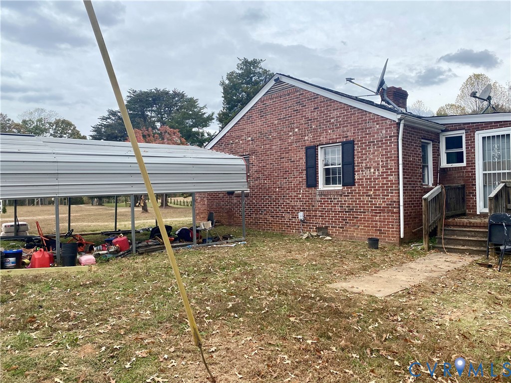 906 Evans Road Powhatan, VA 23139 - Photo 12 of 18 Rear view of house featuring brick siding, a detac