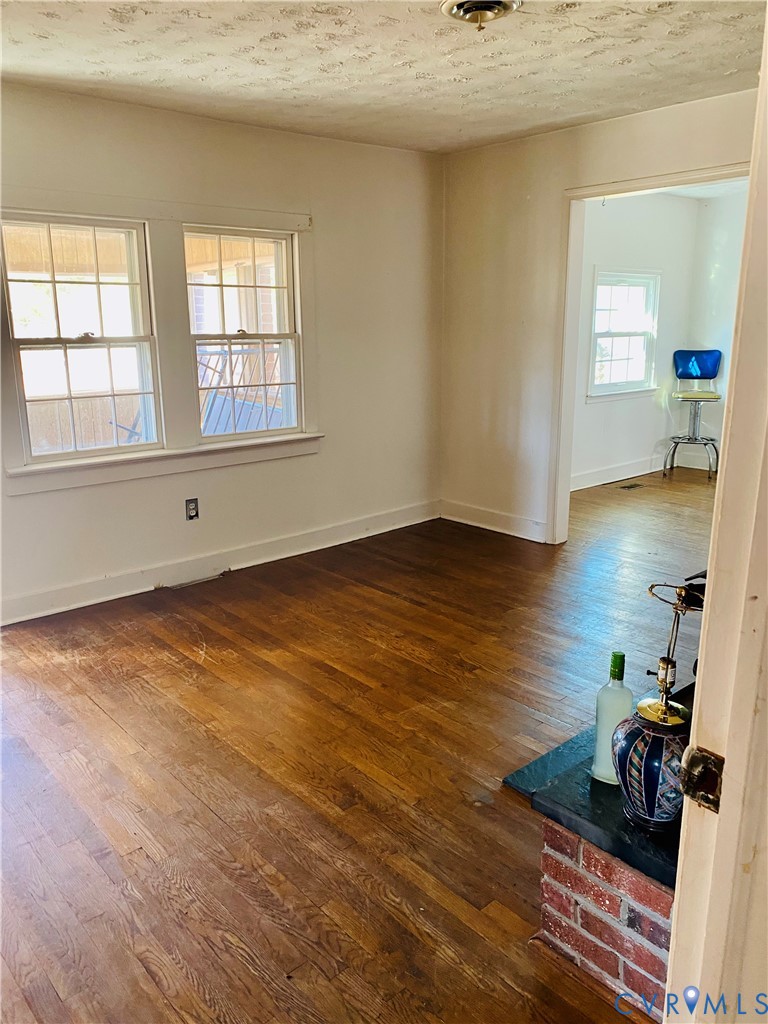 Unfurnished room with dark wood finished floors an