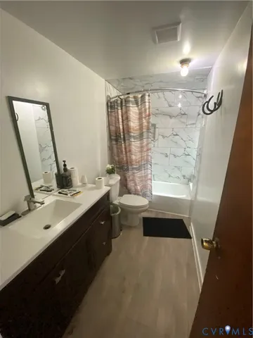 a bathroom with a double vanity sink toilet and shower