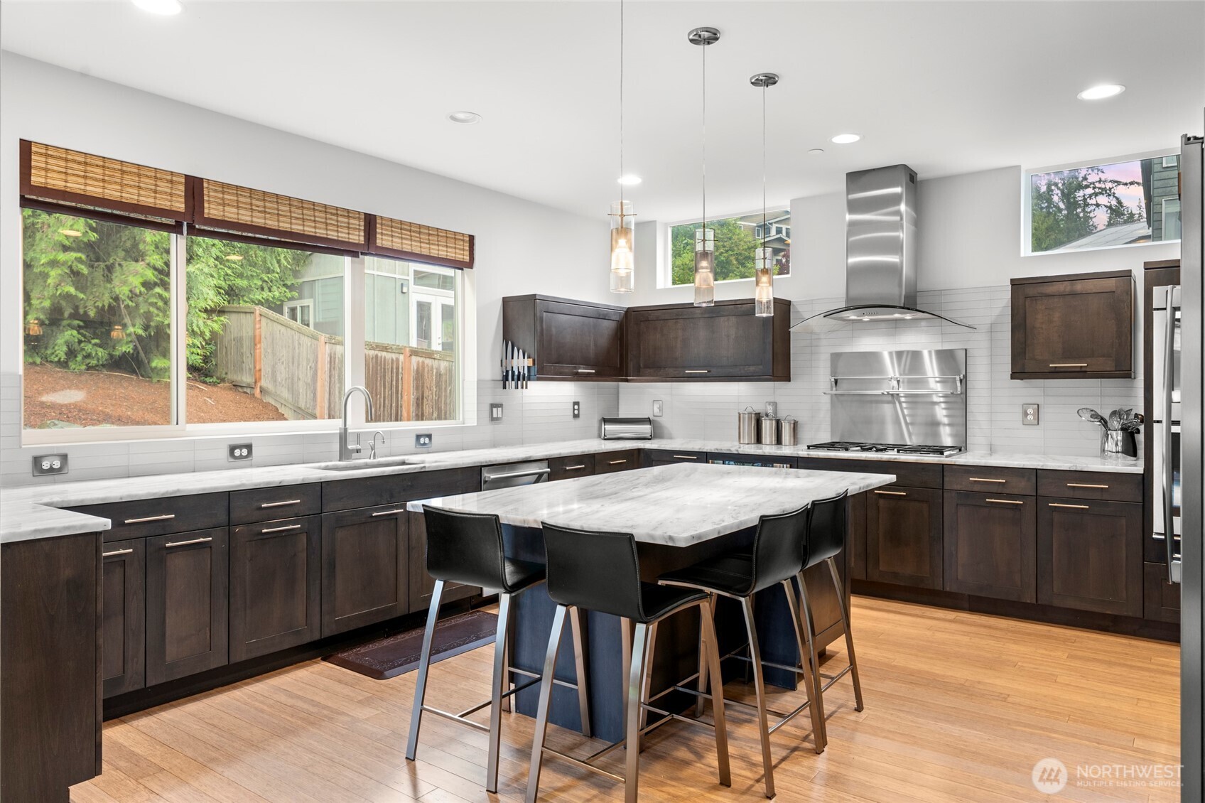 22326 2nd Place Southeast Bothell, WA 98021 - Photo 9 of 40 a kitchen with stainless steel appliances granite countertop a stove top oven a sink a dining table and chairs