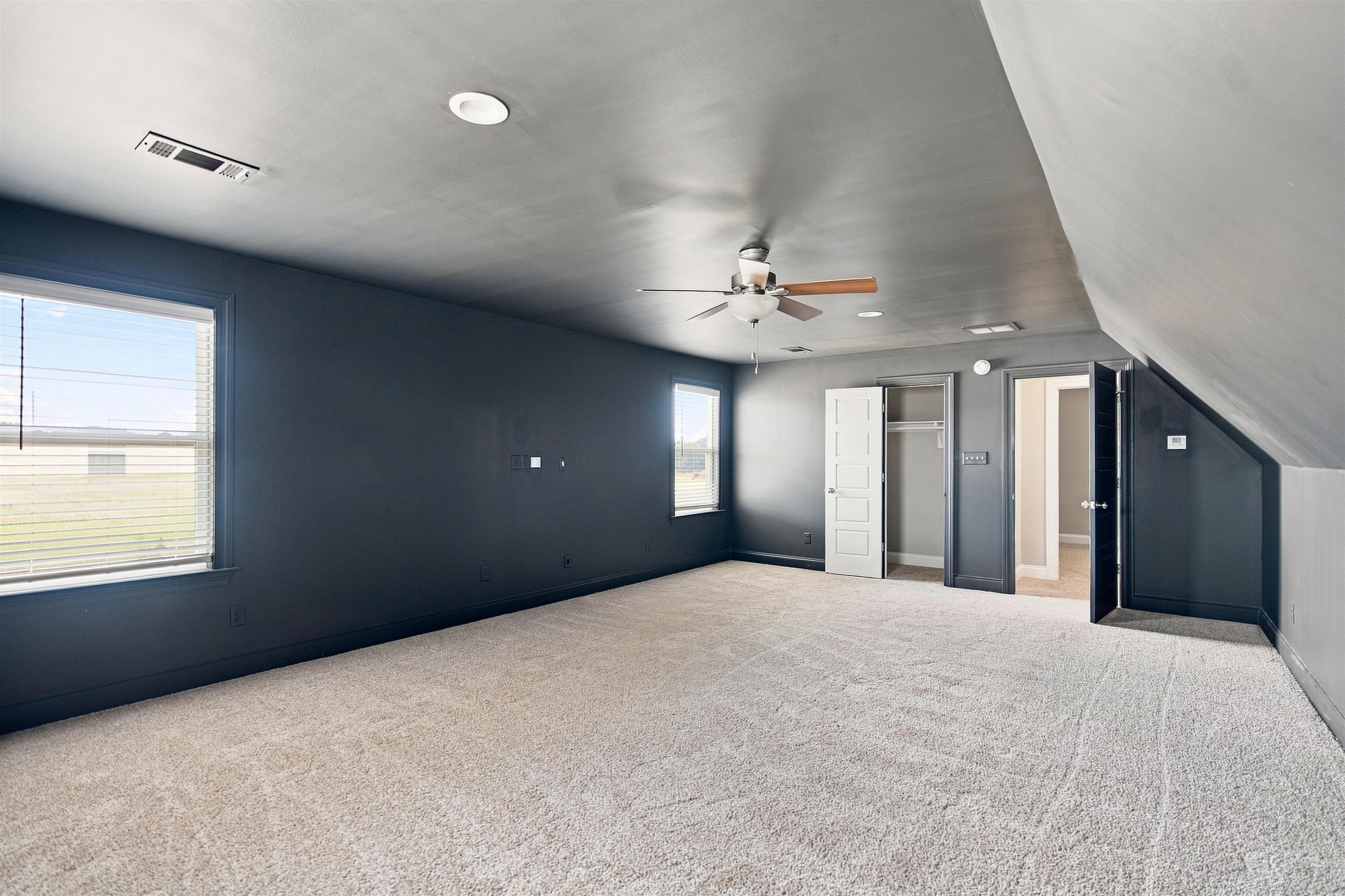70 Trinity Cove Atoka, TN 38004 - Photo 10 of 19 Expansive carpeted room featuring recessed lighting, a ceiling fan, dual windows, and multiple entryways