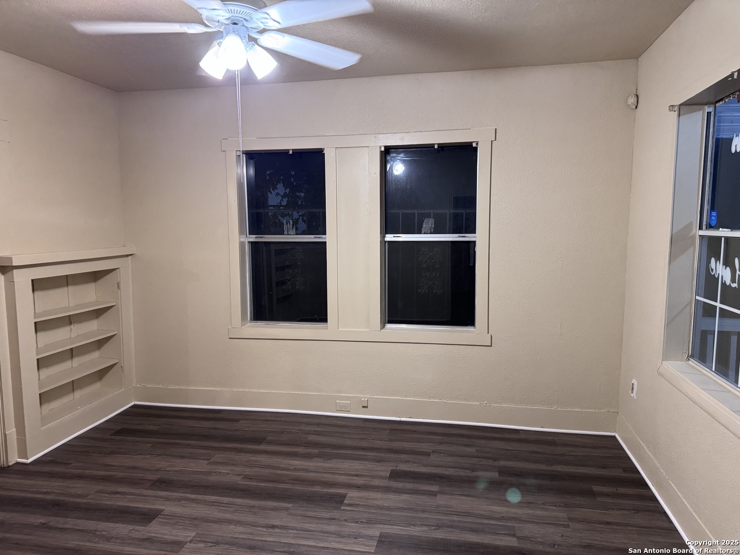 211 Blanco Road San Antonio, TX 78212 - Photo 6 of 34 a view of an empty room with wooden floor and a window