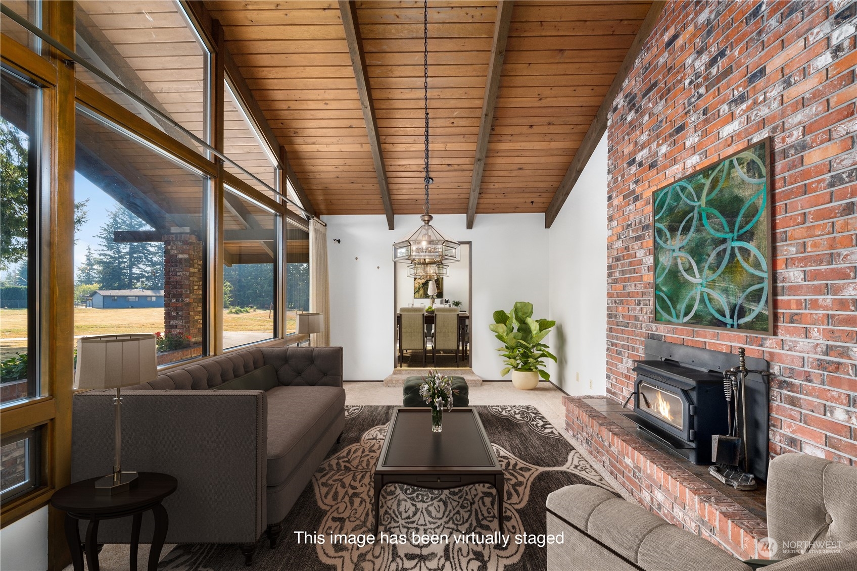 2435 McHugh Avenue Enumclaw, WA 98022 - Photo 16 of 35 a living room with furniture a fireplace and a potted plant