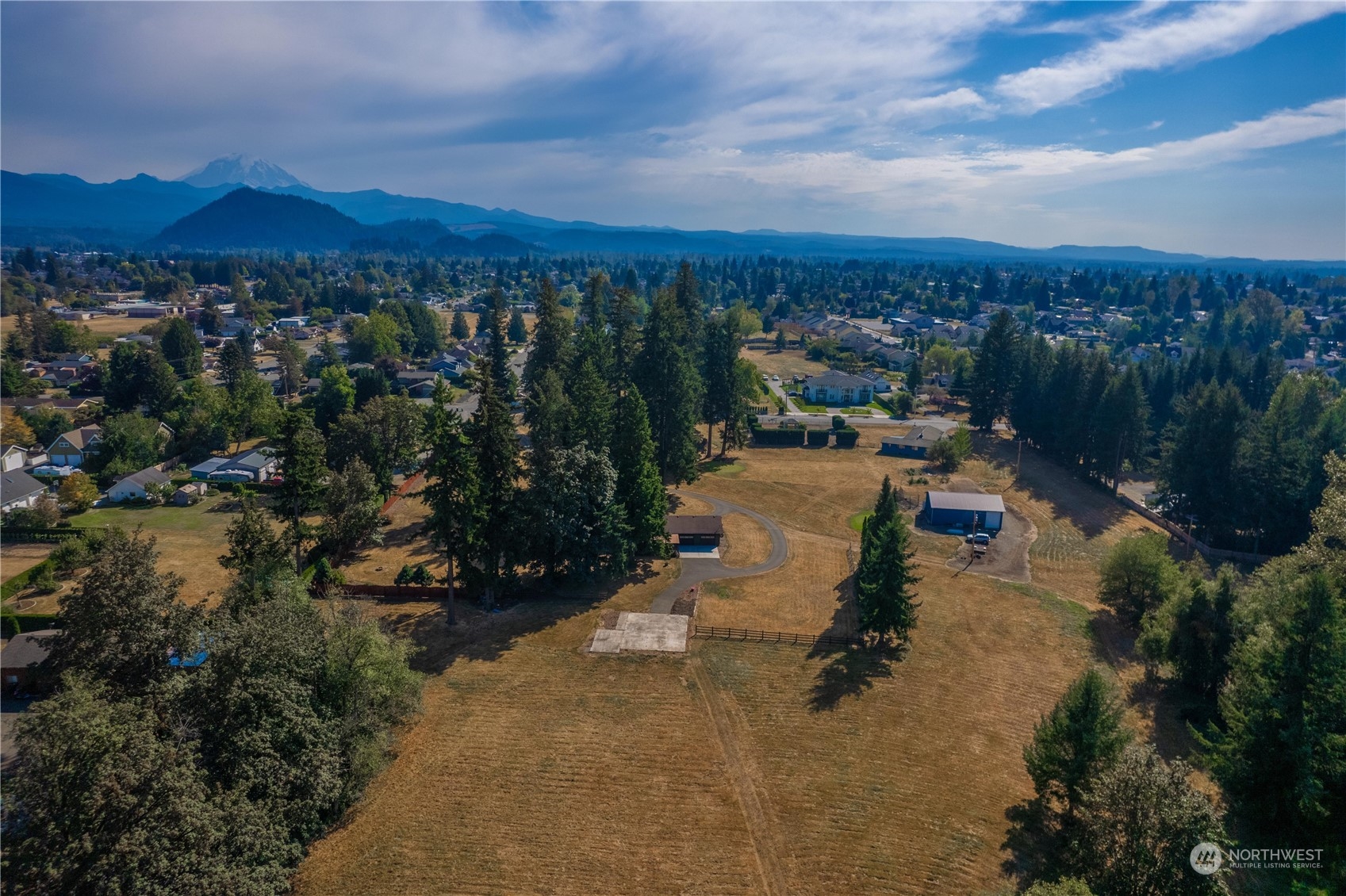 2435 McHugh Avenue Enumclaw, WA 98022 - Photo 31 of 35 a view of a lake in front of a house with a yard