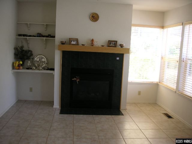 3075 Alpine Creek Road Reno, NV 89519 - Photo 3 of 9 a living room with furniture and a fireplace