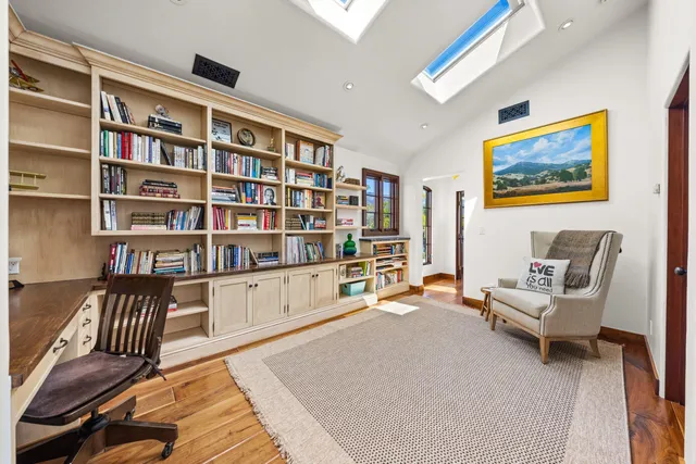 a bedroom with furniture and a book shelf