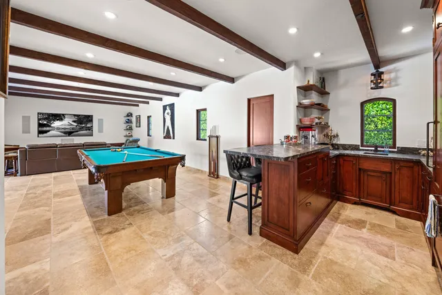 a kitchen with sink and chairs