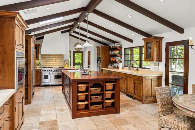 a open kitchen with stainless steel appliances granite countertop a stove and a refrigerator