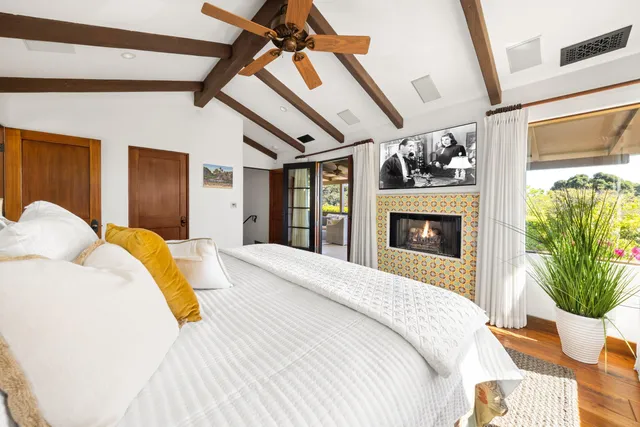 a bedroom with a bed and a fireplace