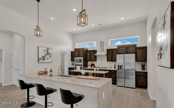 a kitchen with stainless steel appliances a refrigerator and a sink