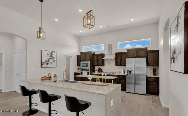 a kitchen with stainless steel appliances a refrigerator and a sink