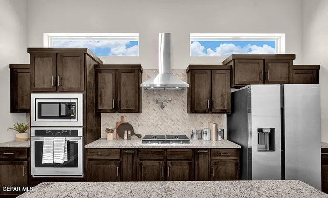 a kitchen with a stove a counter space dining table and chairs