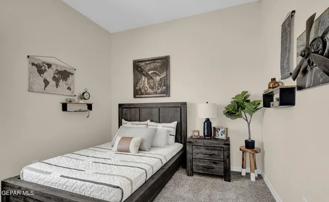 a bedroom with a bed and glass door