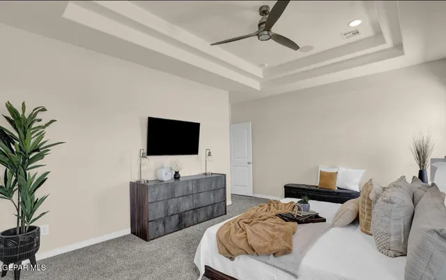 a living room with furniture a flat screen tv and a chandelier