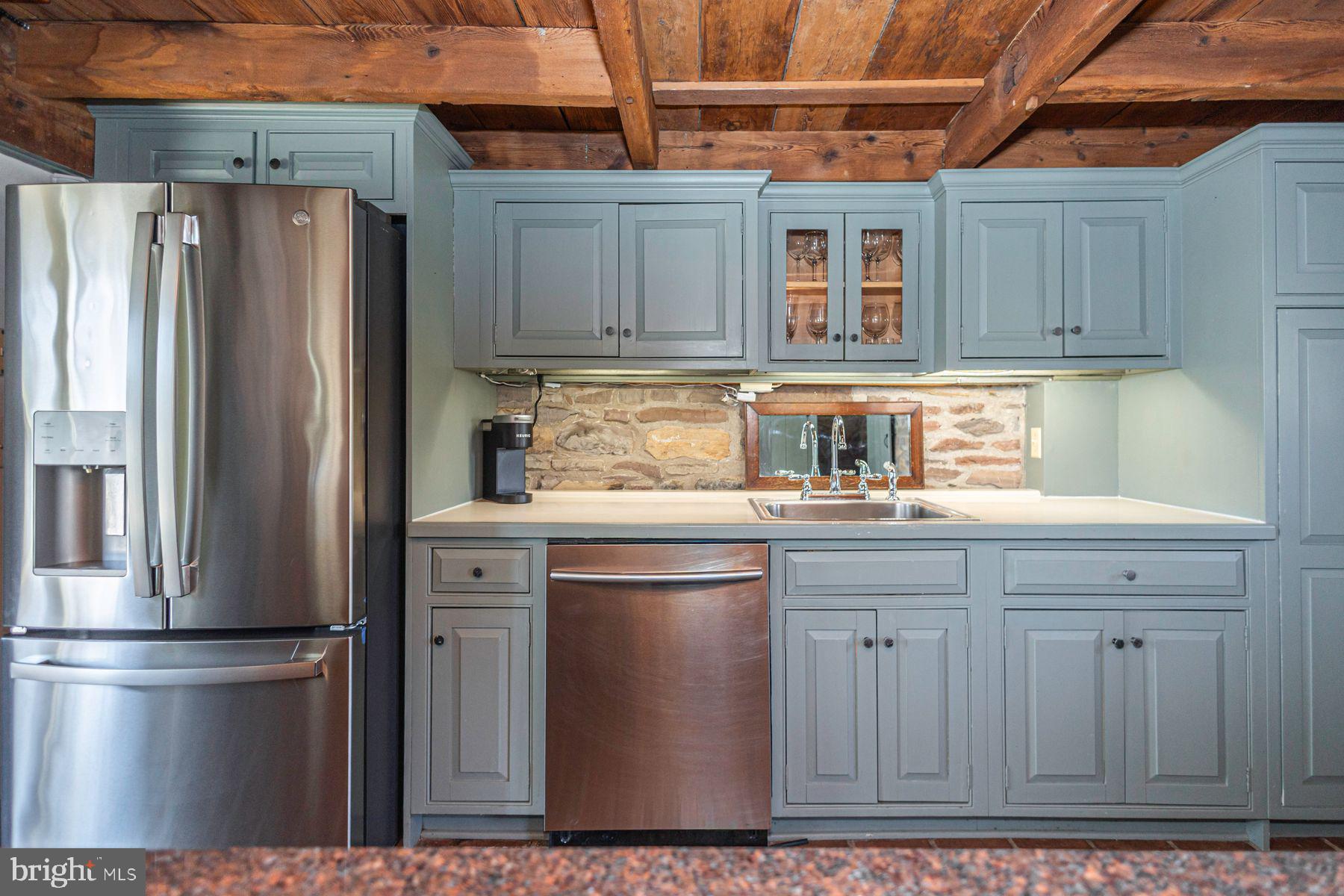 718 Telegraph Road Perkasie, PA 18944 - Photo 16 of 47 a kitchen with stainless steel appliances granite countertop a refrigerator a sink and wooden cabinets