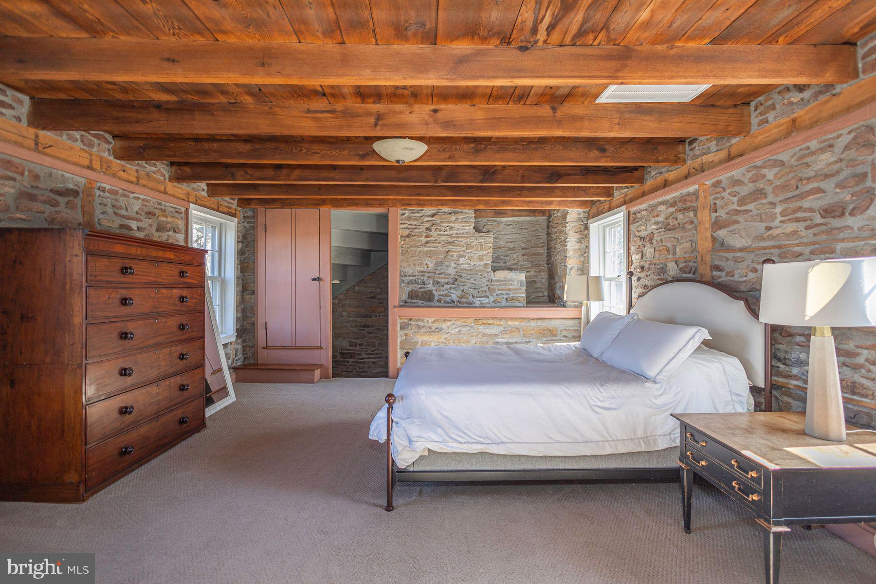 718 Telegraph Road Perkasie, PA 18944 - Photo 21 of 47 a bedroom with a bed a lamp and a large window