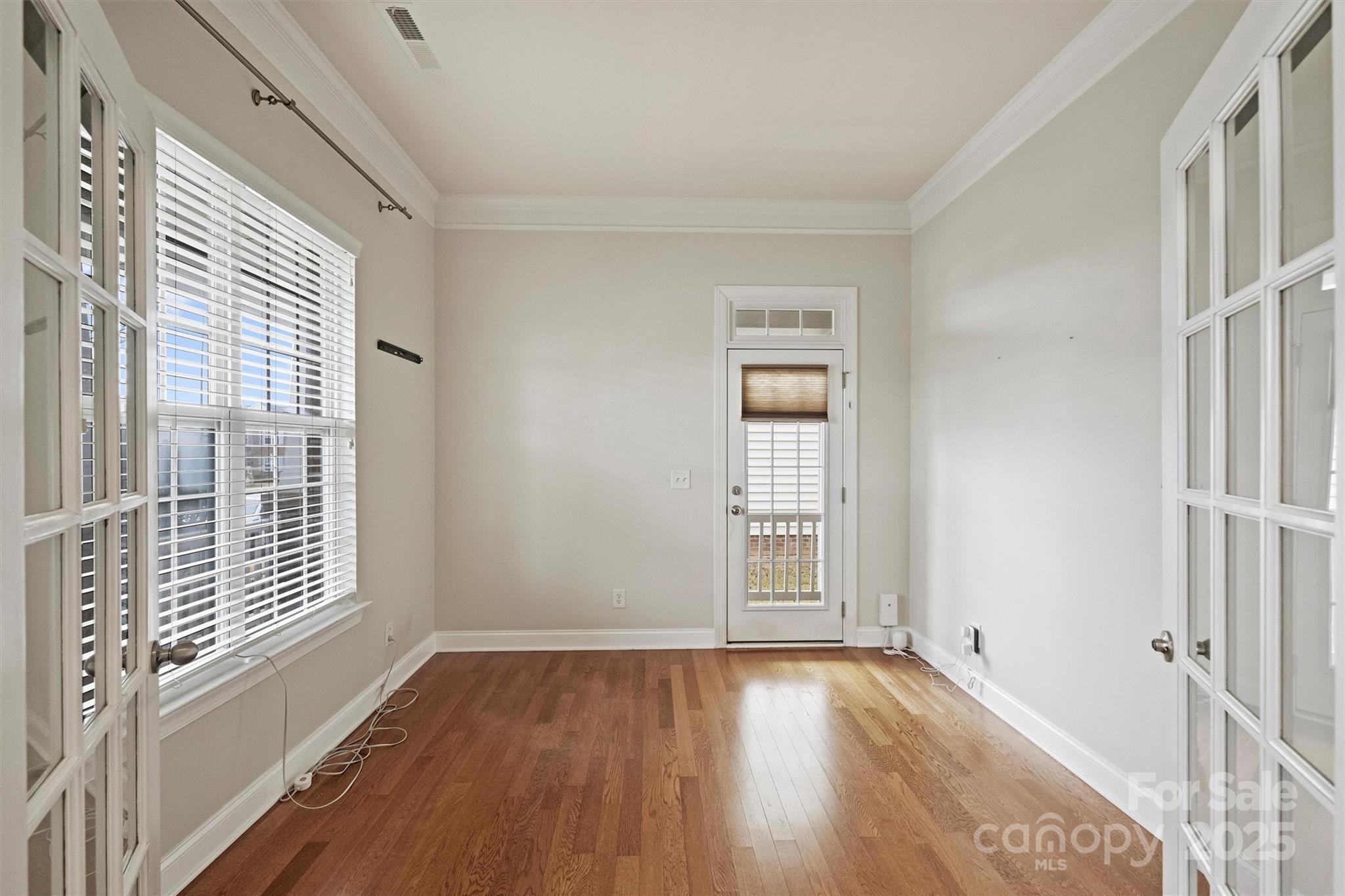 10513 Serape Road Charlotte, NC 28277 - Photo 4 of 45 an empty room with wooden floor and windows