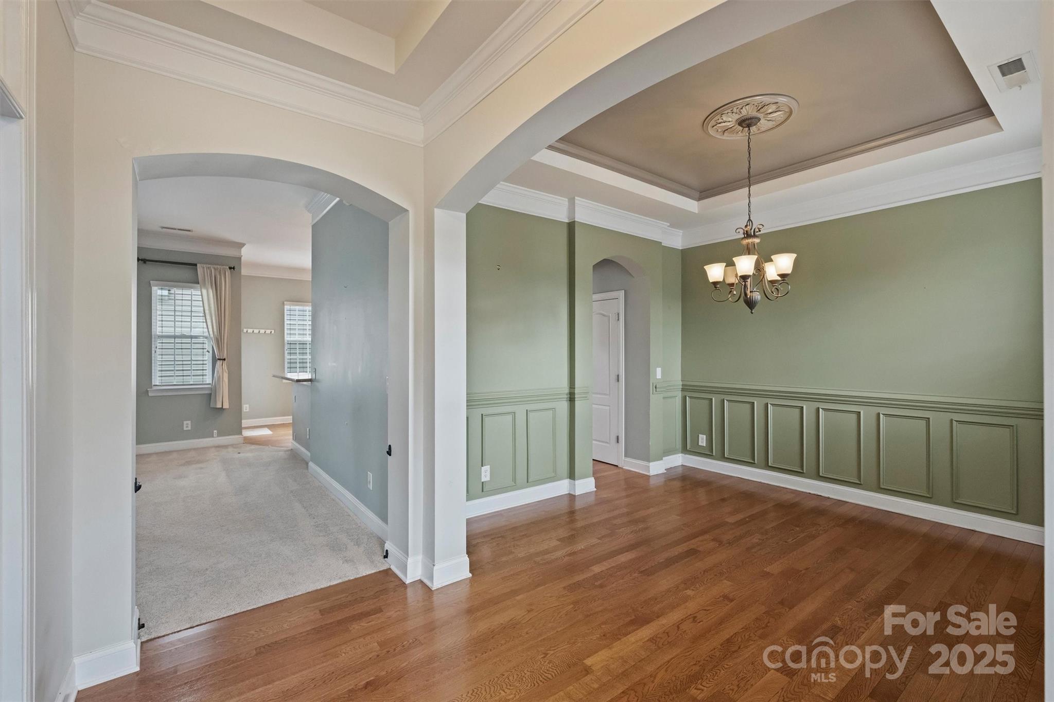 10513 Serape Road Charlotte, NC 28277 - Photo 7 of 45 wooden floor in a hall with a chandelier