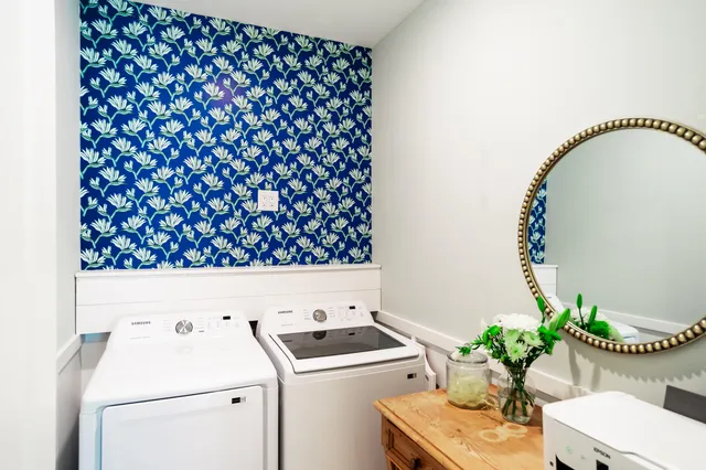 a utility room with dryer and flowers
