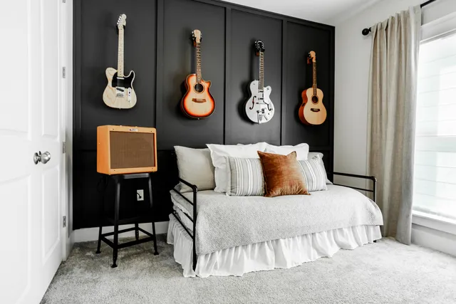 a bedroom with a bed and painting on the wall