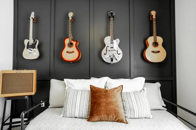 a bedroom with a bed and painting on the wall